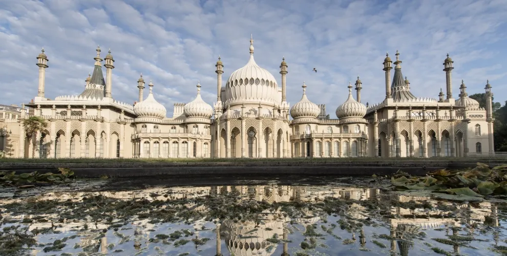 Brighton's Royal Pavilion with ornate domes and minarets reflected in tidal pools, near Loxdale English Centre