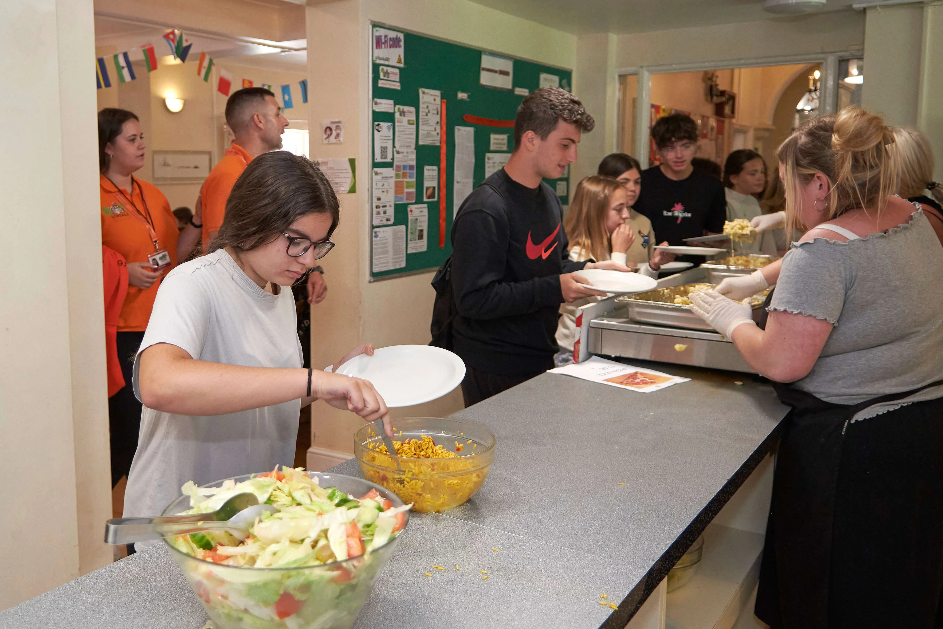 Students serving themselves salad and food in the canteen at Loxdale English school in Brighton