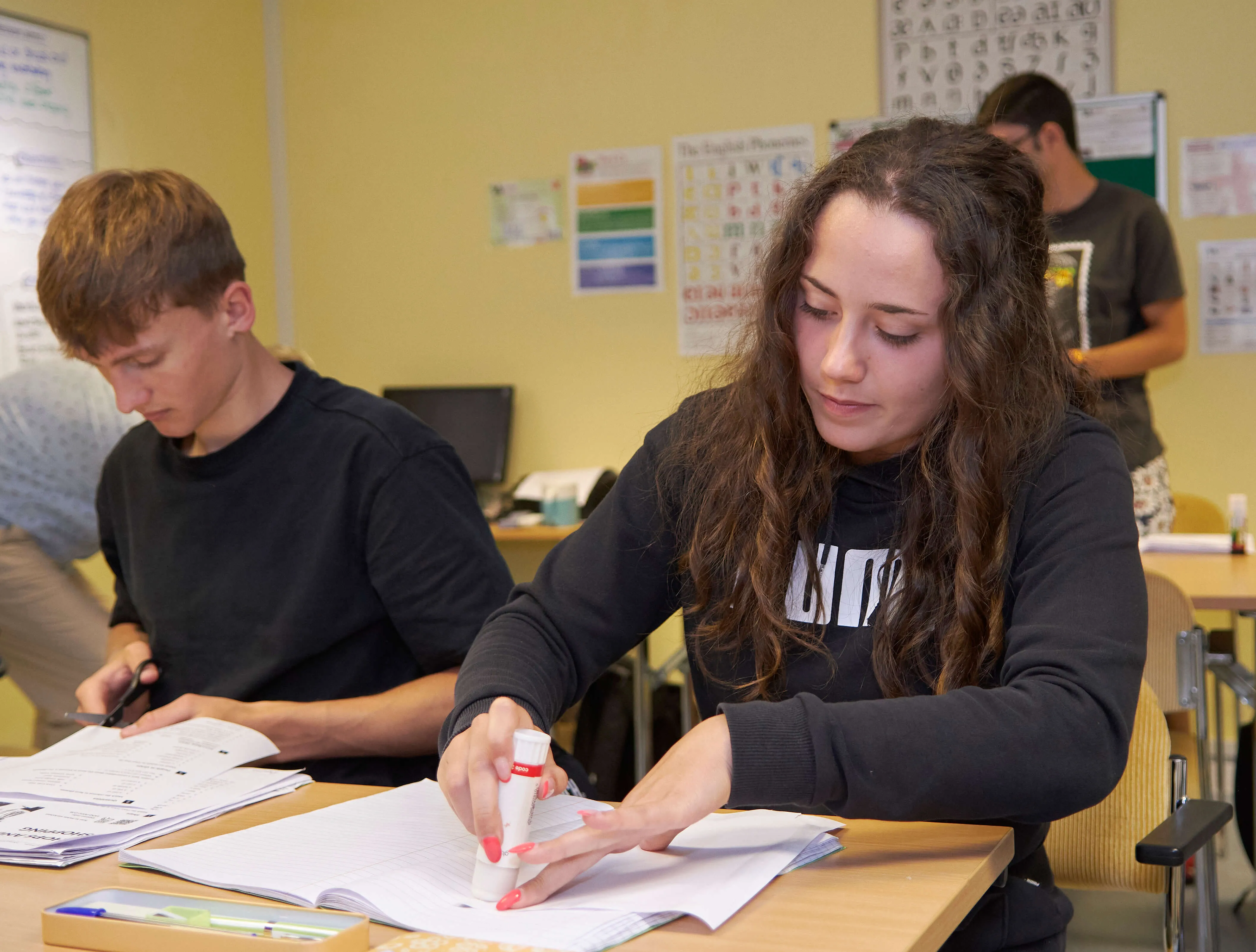 Students working with textbooks and highlighters in small-group English class at Loxdale Brighton