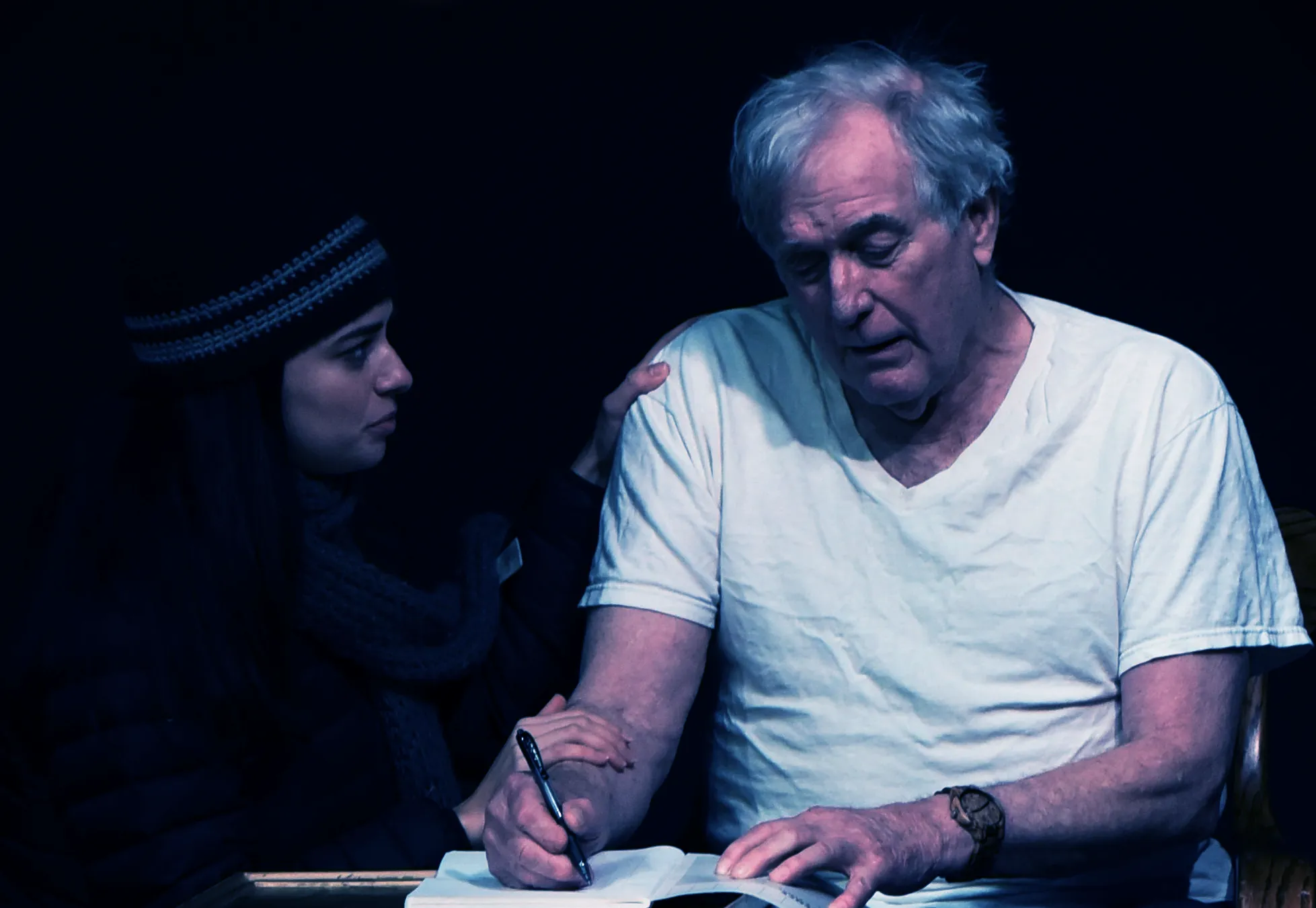 Mature student writing in notebook during English course at Loxdale Brighton language school