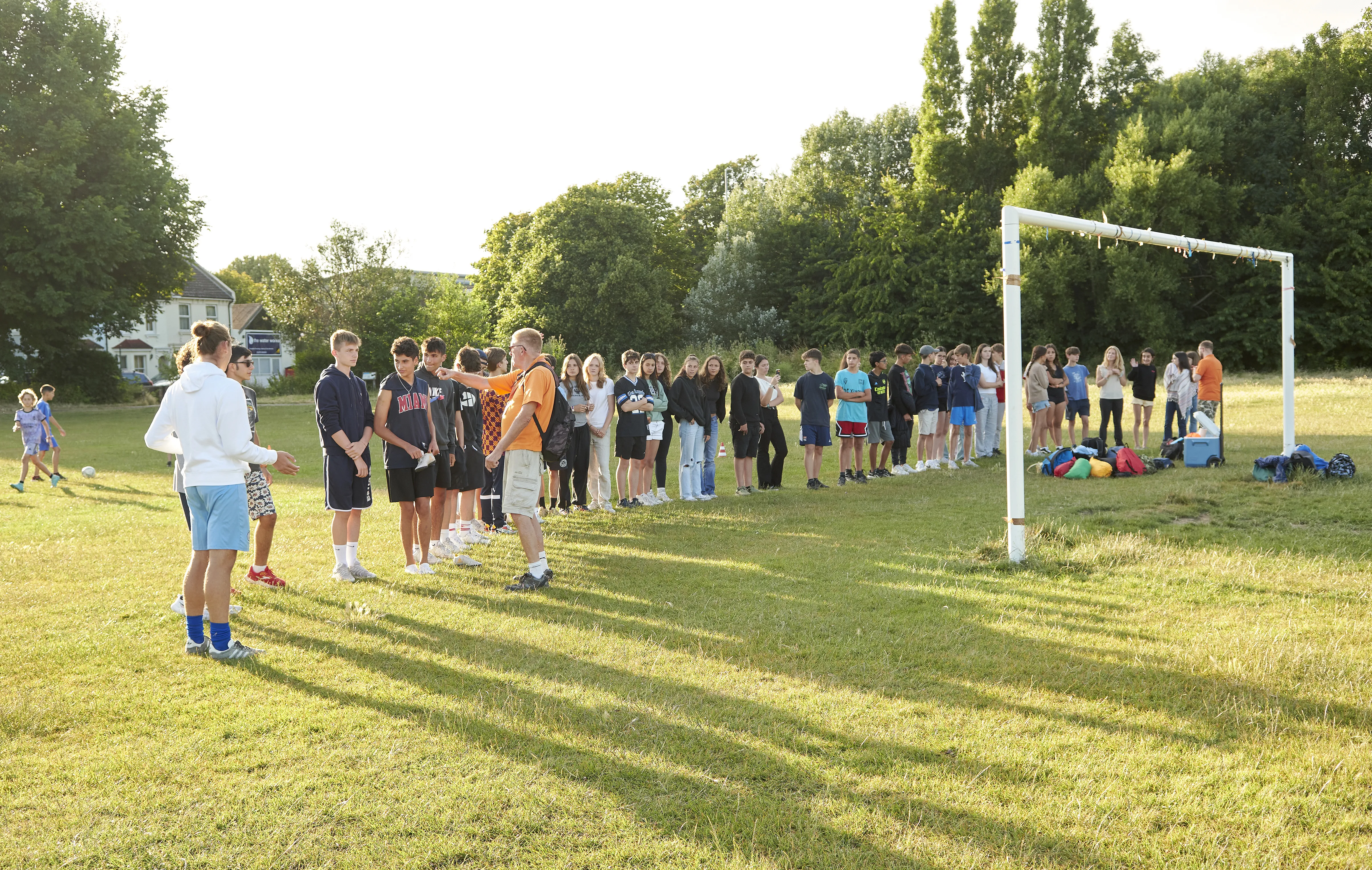 Students gathering on sports field for outdoor activities and games at Loxdale