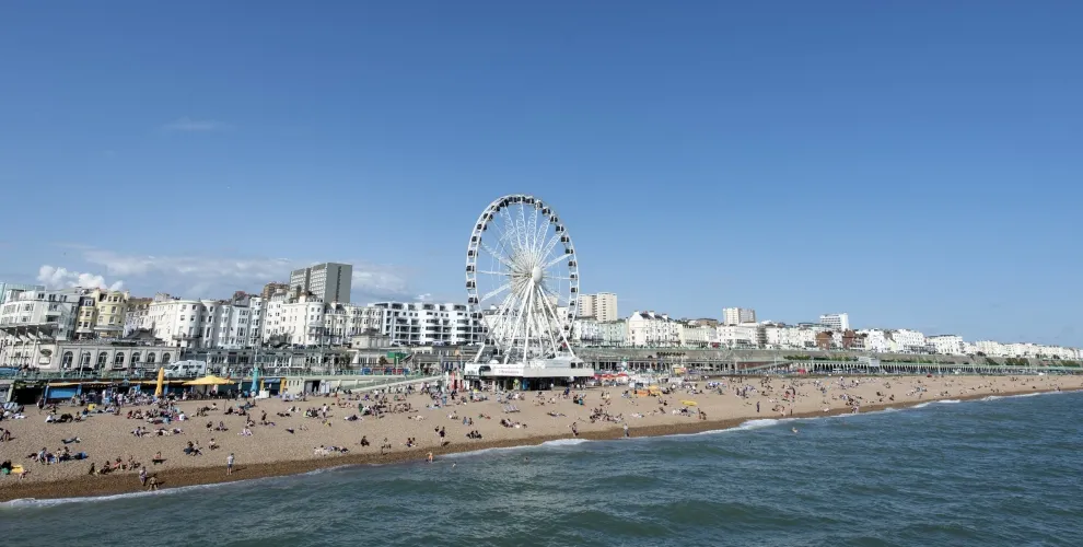 Brighton seafront with observation wheel, white buildings, beach and sea - study English at Loxdale