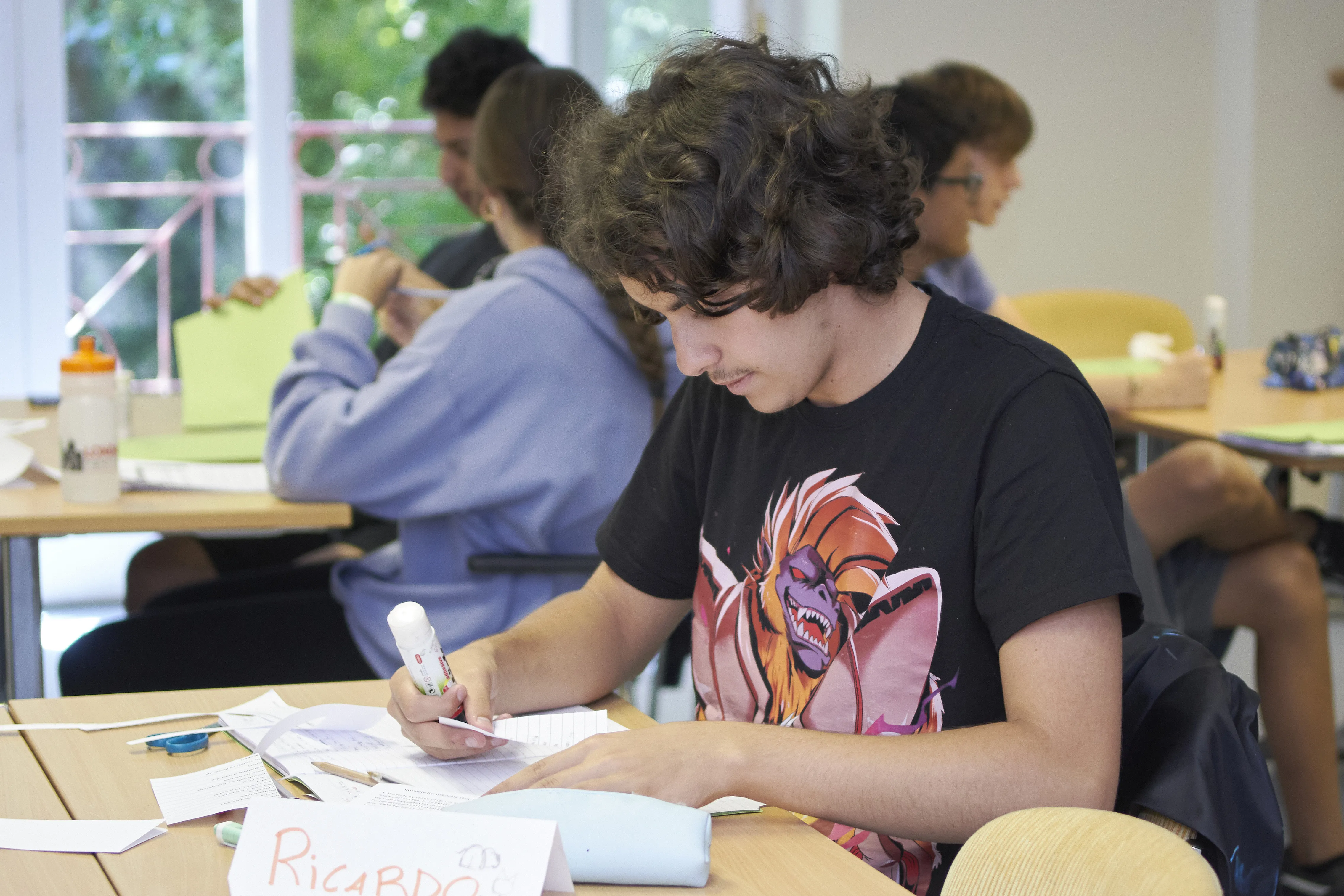 Young student writing during English class at Loxdale Brighton language school summer course