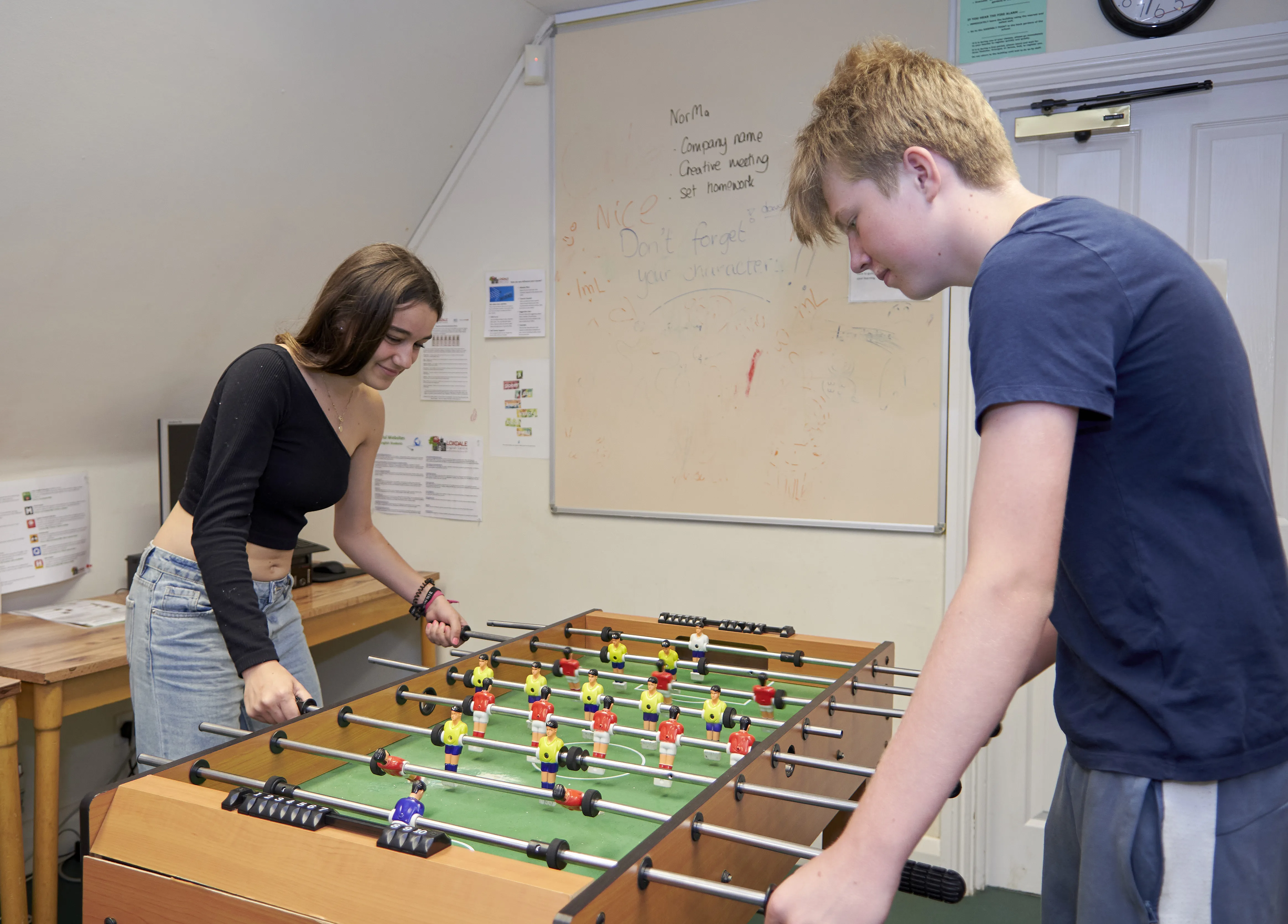 Two young learners playing foosball at Loxdale English Centre Brighton during summer course break