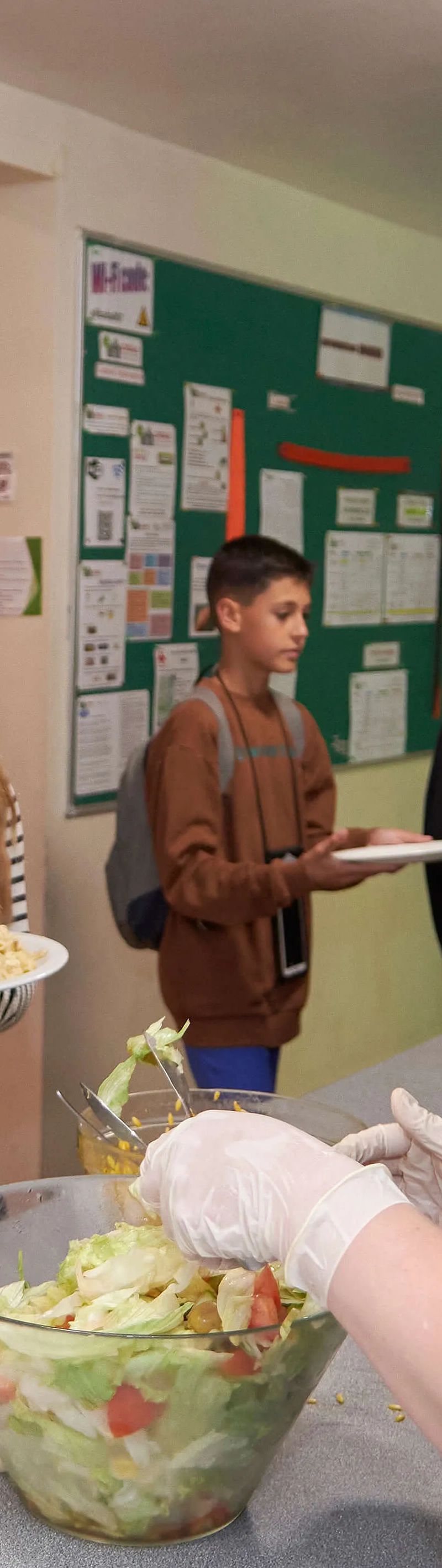 Students being served fresh food in the canteen at Loxdale English school