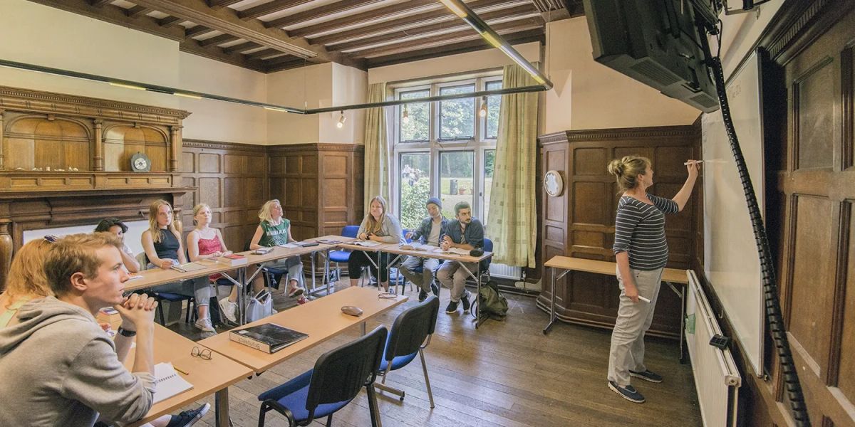 Adult students studying English together in a classroom in the UK