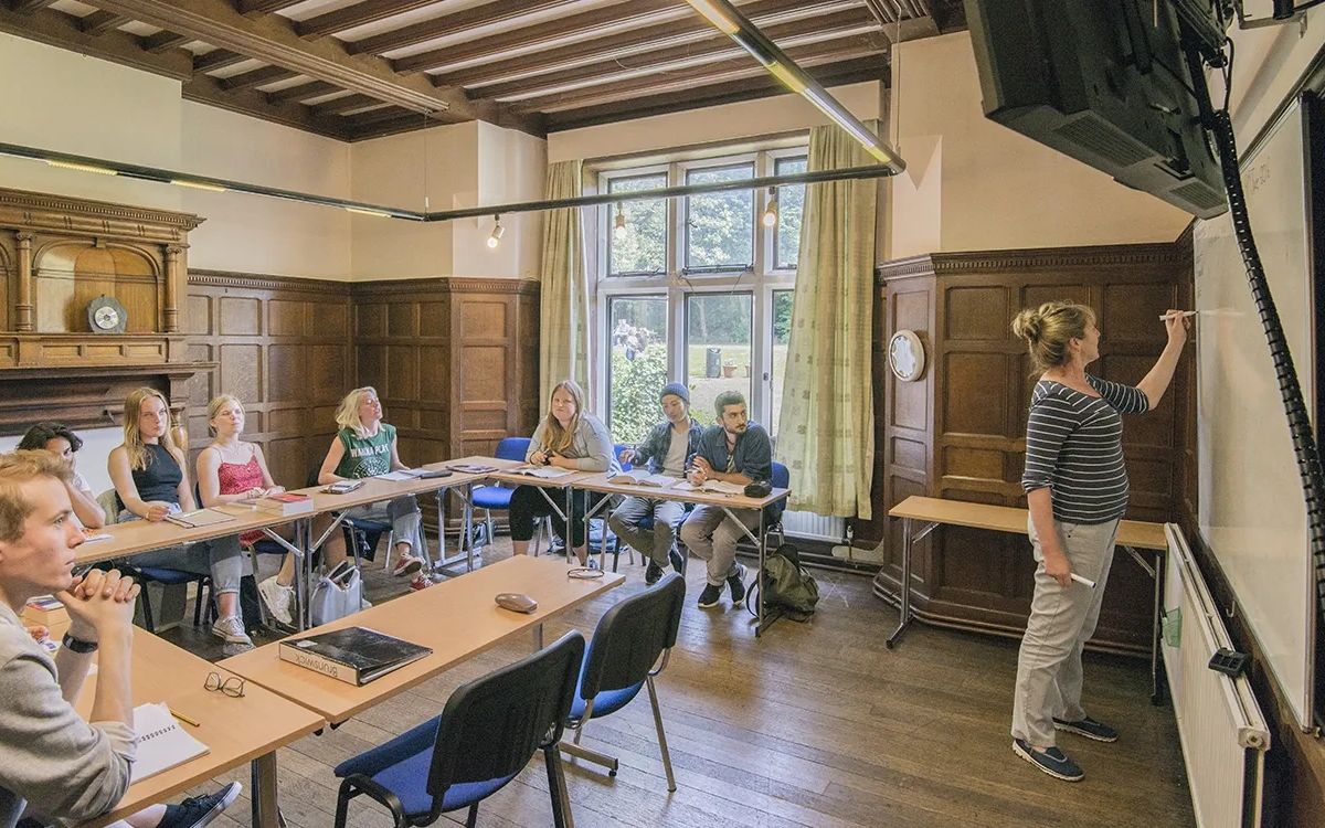 Adult students studying English together in a classroom in the UK