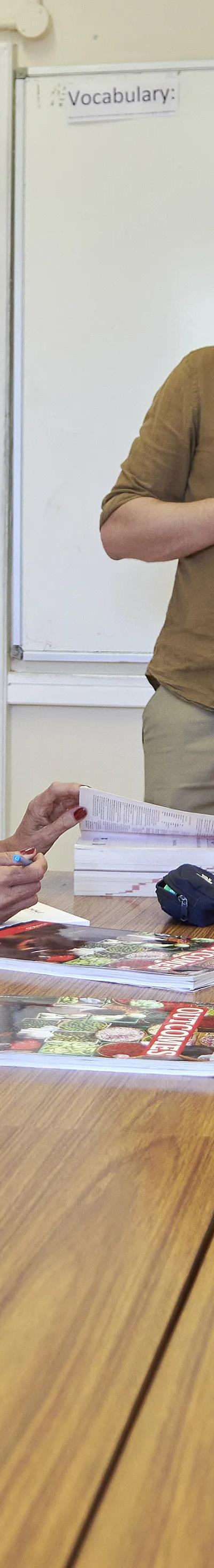 Teacher leading small-group English lesson at Loxdale language school in Brighton with students at table