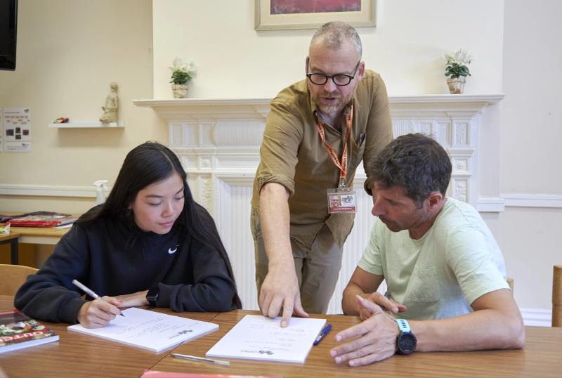 Focused adult students in an Intensive English class at Loxdale Brighton