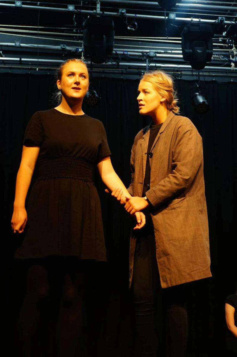 Two drama students performing on stage at Loxdale English Centre Brighton during theatrical course