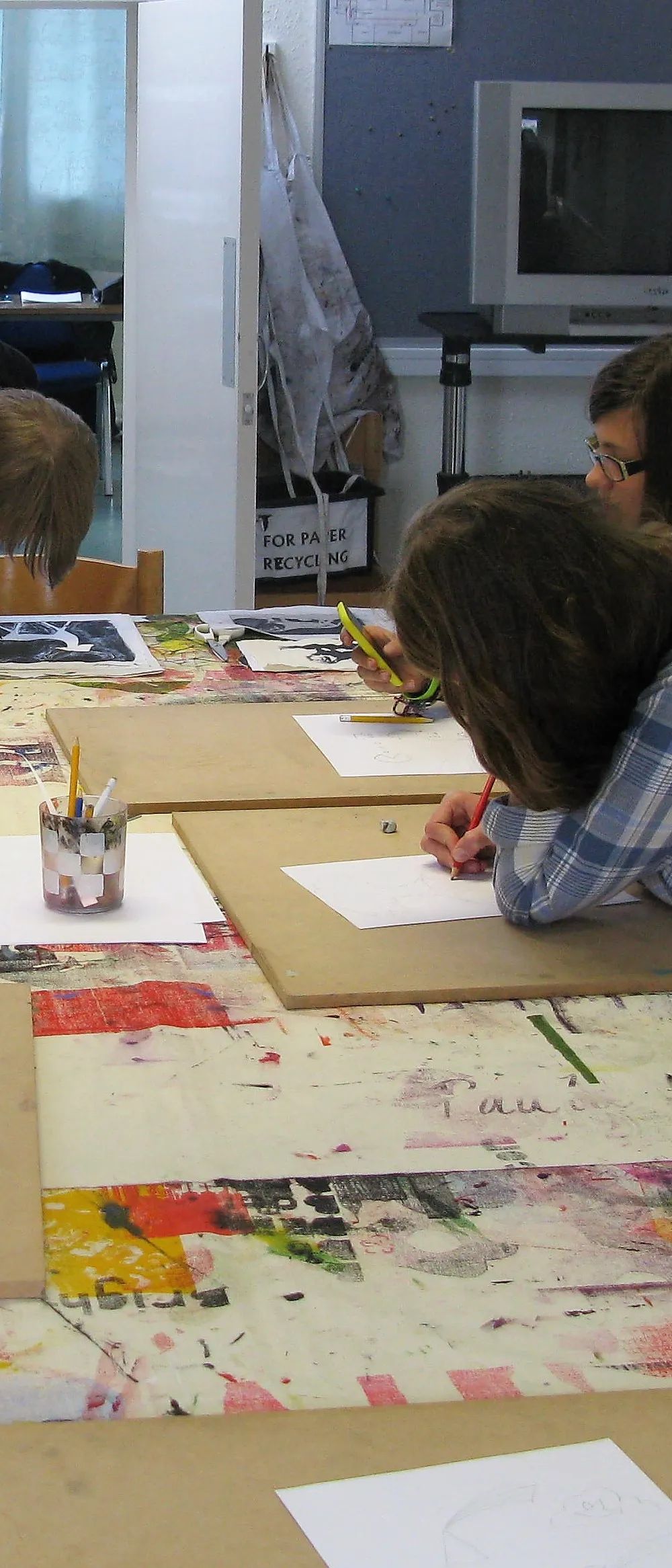 Adult students creating vibrant screen-printed artworks in the English Plus art studio at Loxdale Brighton
