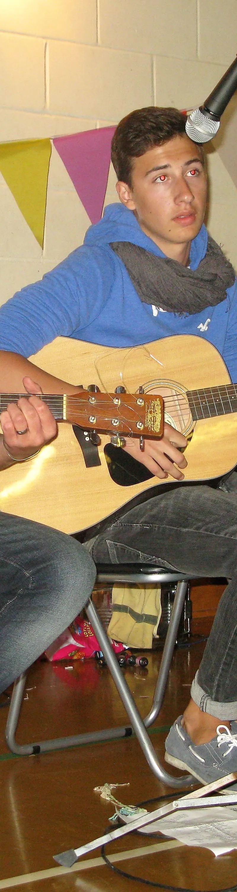 Three young men performing acoustic music at Loxdale English Centre Brighton social activity event
