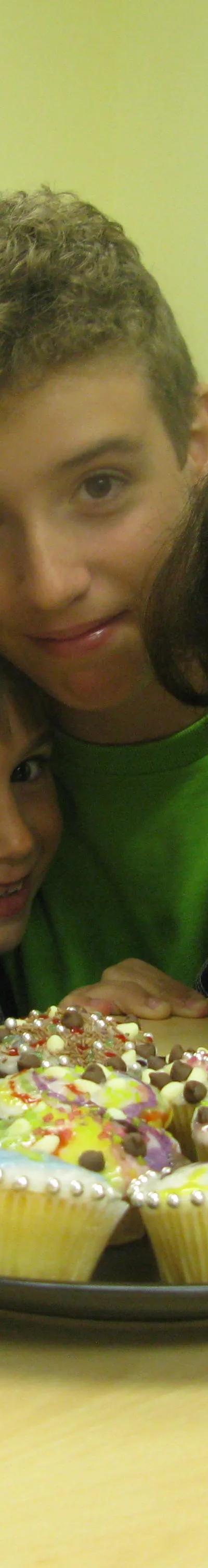 Six happy students gathered around decorated cupcakes at Loxdale evening event