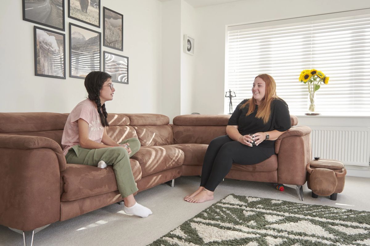 A Brighton host mum chatting with an international student in her sunny living room