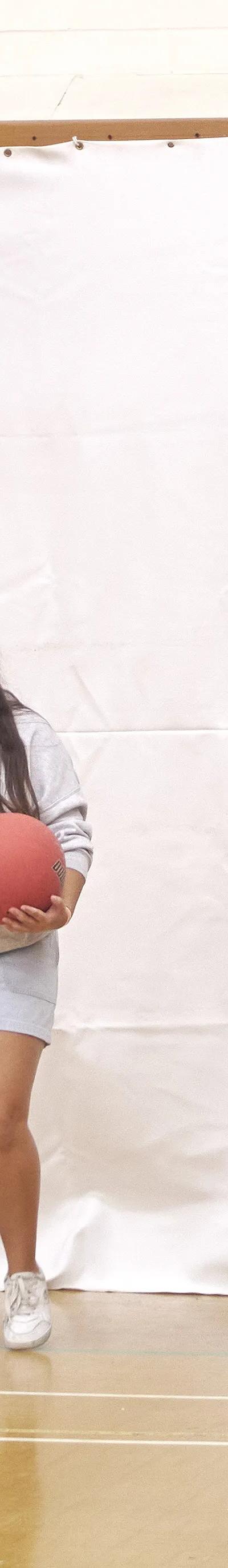 Students playing dodgeball in gymnasium at Loxdale English language school Brighton