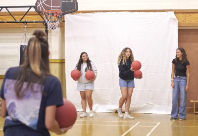 Students playing dodgeball in gymnasium at Loxdale English language school Brighton