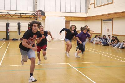Students playing tug of war in gymnasium at Loxdale English Centre Brighton