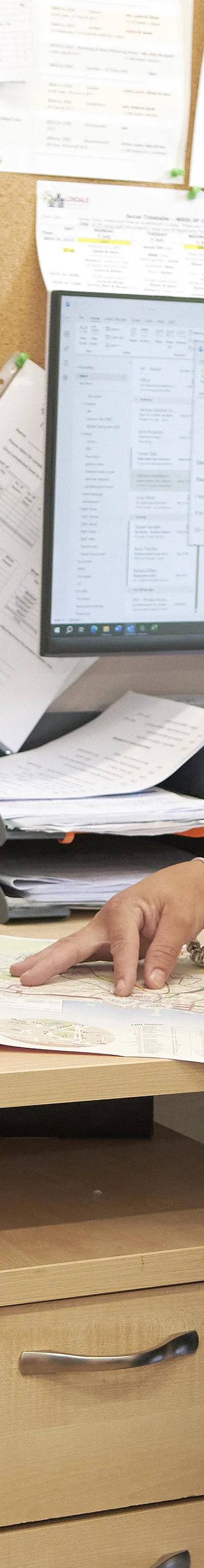 Loxdale English Centre support staff member assisting student with paperwork in Brighton office