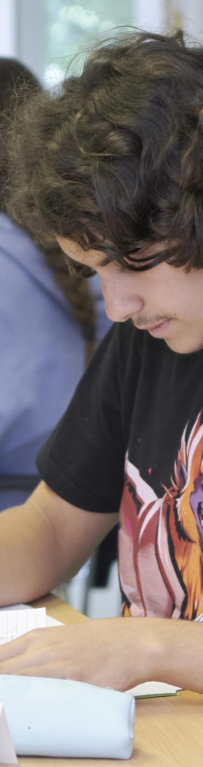 Young student writing during English class at Loxdale Brighton language school summer course